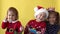 Emotion Cute Happy Cheerful 3 Siblings Friends Baby Girl And Boy in Santa Suit Smiling Laughing Looking On Camera At