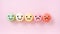 Emotion face on multi colored macarons , good feedback rating and positive customer review, experience, satisfaction survey ,