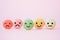 Emotion face on sweet macaron, , focus of happy green and defocus others, on sweet pink  background, customer review, feedback,
