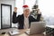 Emotional adult in Santa hat lifting hands while looking at computer screen