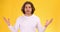 Emotional angry man feeling anger, emotionally talking to camera and screaming furiously, yellow background