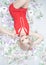 An emotional blonde girl in a red dress is lying on scattered money with toilet paper. a rich person during an epidemic is ready