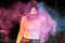 Emotional brunette woman posing with blowing Holi powder at the