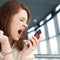 Emotional Business woman with phone at cafe