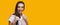 Emotional caucasian girl gesturing fight while shouting and posing on yellow background with blank space