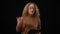 Emotional Caucasian woman talking gesturing standing at black background. Portrait of agitated female speaker presenting