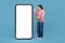 Emotional chinese woman looking at smartphone empty screen