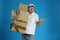 Emotional courier with damaged cardboard boxes on blue. Poor quality delivery service