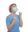 Emotional doctor with protective mask on white background. Strong immunity concept