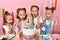 Emotional excited four cute little girls being surprised at beautiful cake