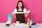 Emotional expressive woman in kitchen, shouting female surrounded with tools for cooking food, lady kneads dough with angry facial