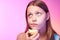 Emotional funny teen girl eating apple
