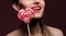 emotional girl with a lollipop over pink background