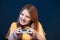 Emotional girl playing video game with joystick