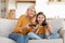 Emotional grandmother and girl teenager granddaughter playing video games