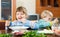 Emotional happy children eating at table