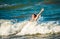 Emotional little girl splashing in the stormy sea