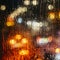 Emotional melancholic abstract background with defocused lights bokeh in London, UK behind rain drops in window glass