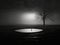 Emotional minimalistic image of solitude loneliness in artistic darkness style. Dark silhouette of a man stuck in