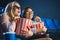 emotional multiracial women in 3d glasses with popcorn watching film together