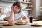 Emotional overweight boy at table with fast food