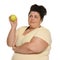 Emotional overweight woman with apple on background