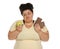 Emotional overweight woman with apple and chocolate