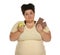 Emotional overweight woman with apple and chocolate