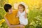 Emotional photo of a grandmother and granddaughter in a field of sunflowers