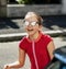 Emotional photos of a schoolgirl girl who runs along the street in the bright sun