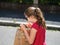 Emotional photos of a schoolgirl girl who runs along the street in the bright sun