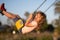 Emotional portrait of a child in the playground. Outdoor kids activity. Little boy having fun on a swing on the