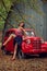 Emotional portrait. Pin-up girl posing near by a red russian retro car.The model laughs loudly, flirtatiously showing slender legs