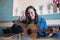 Emotional portrait of a woman blogger with an acoustic guitar shows the gesture of peace in the camera, writes a personal blog