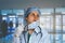 Emotional portrait of young desperate and tired woman doctor in a uniform removing the mask from the face against the background o