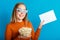 Emotional portrait of young woman in cinema glasses. Smiling teenager girl movie viewer in glasses holding popcorn and