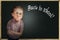 Emotional pupil boy near chalkboard