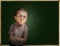Emotional pupil boy near chalkboard
