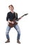 Emotional rock musician playing hard rock music on electric guitar looking at camera