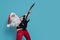 Emotional Santa Claus plays on electric guitar on color background. Christmas music. New Year party