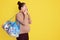 Emotional shocked pregnant woman holds bag with things for maternity home, prepares different items for newborn child, looking