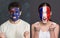 Emotional soccer fans with painted flags on faces