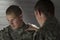 Emotional soldier talking with peer, horizontal