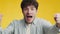 Emotional sport fan. Close up portrait of young excited man football supporter cheering on favorite soccer team