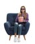 Emotional teenage girl with 3D glasses and popcorn sitting in armchair during cinema show