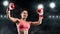 Emotional woman boxing champion raising hands up at ring