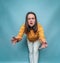 Emotional woman posing on a blue background. Annoyed angry woman. Family quarrels, scandals