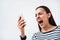 Emotional woman standing on white background