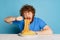 Emotional young hairy red-bearded man tasting large portion of noodles, pasta isolated on blue studio background.