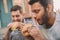 Emotional young men eating gourmet hamburgers outdoors